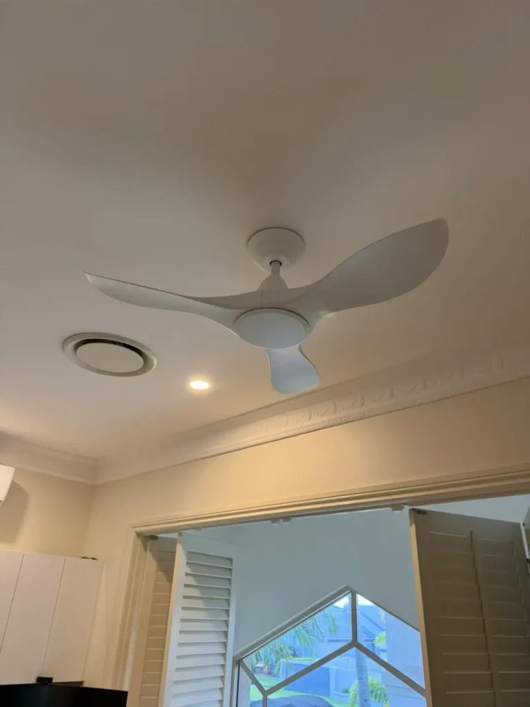 Modern white ceiling fan installation in residential home with LED lighting