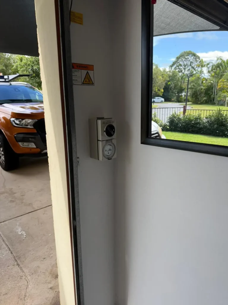 Wall mounted EV charger installed inside residential garage for electric vehicle charging