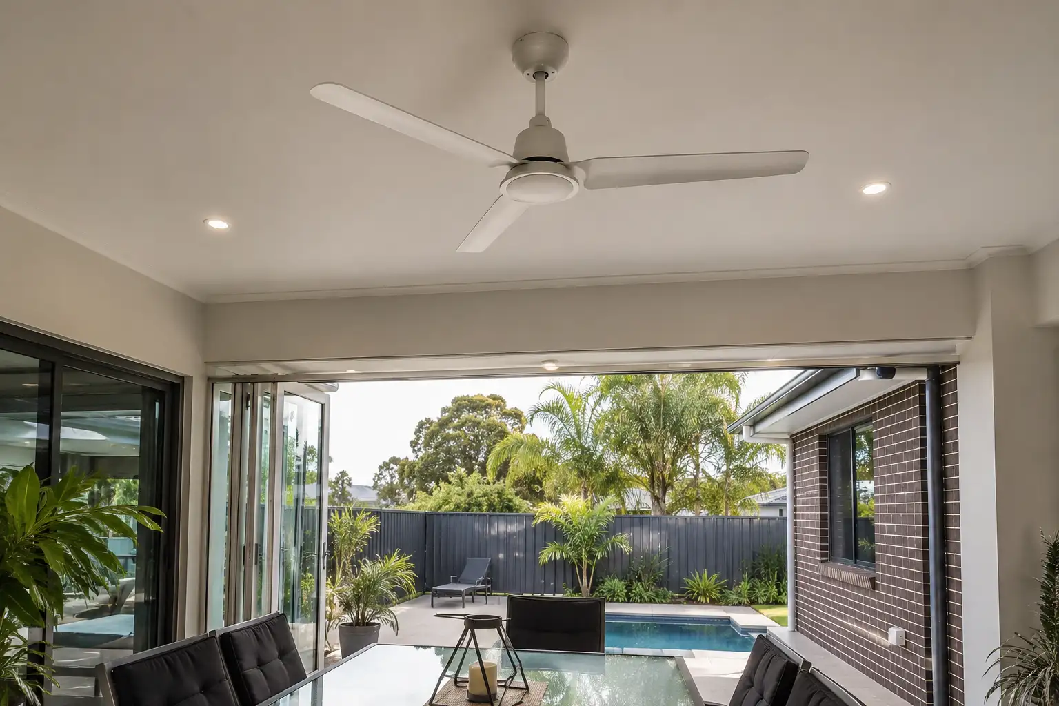 Professional indoor and outdoor ceiling fan installation in a modern Gold Coast home with indoor-outdoor living spaces